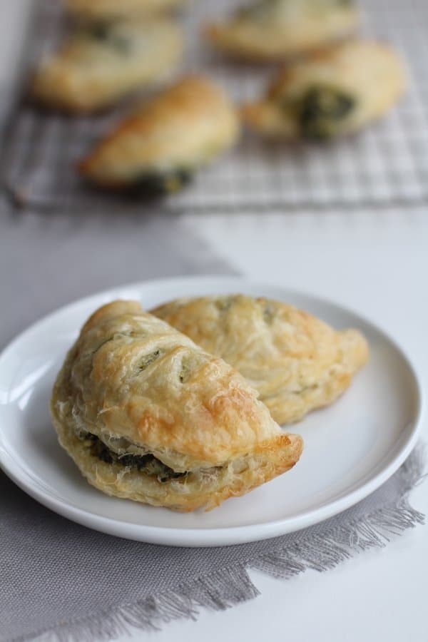 spinach artichoke hand pies on a white plate