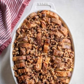 square image of baked banana french toast in an oval casserole dish