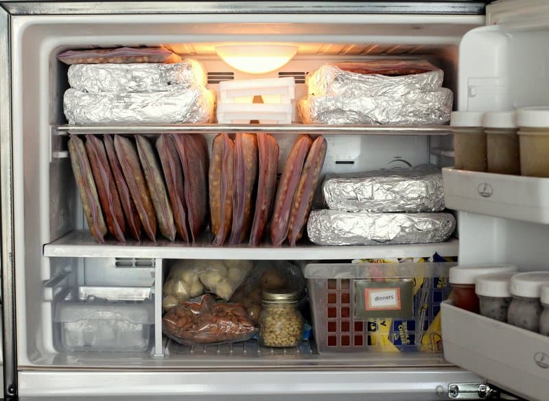 a freezer full of food with the door open