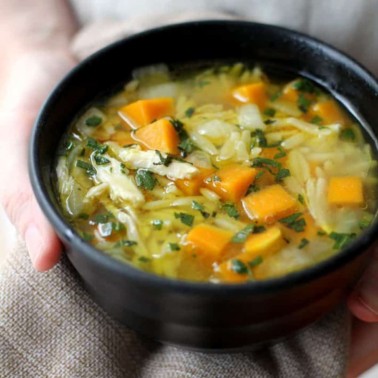 bowl of soup with orzo, chicken, and butternut squash