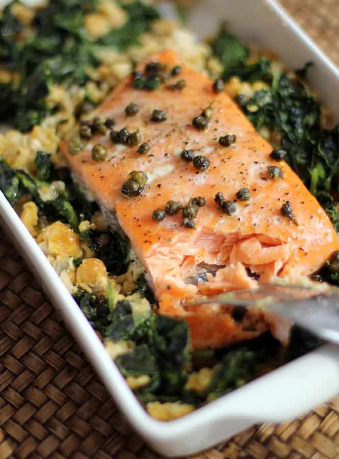 salmon and greens in a white baking dish