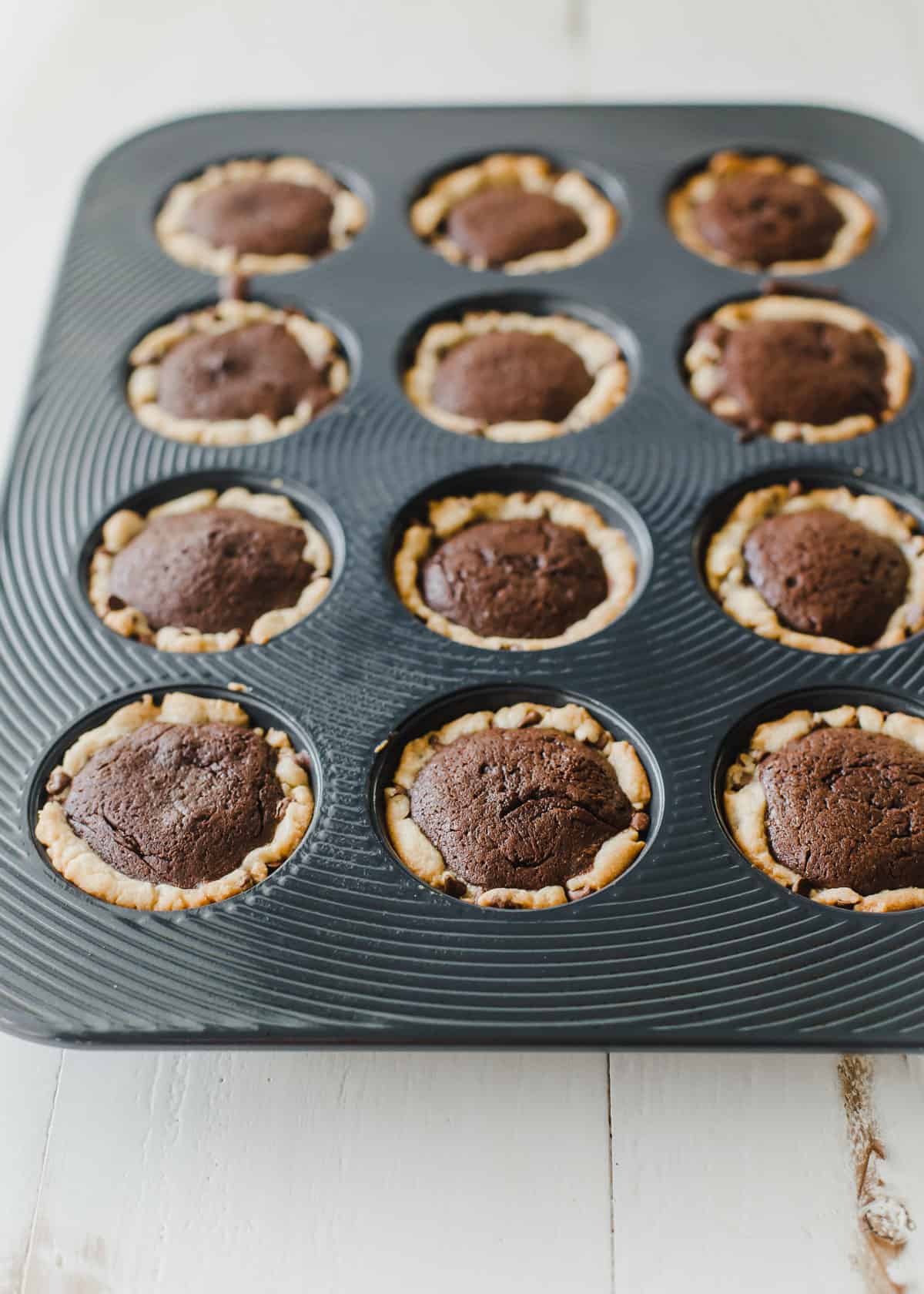 chocolate chip brownie tarts in regular muffin tin