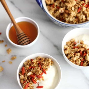 granola and yogurt in white bowls