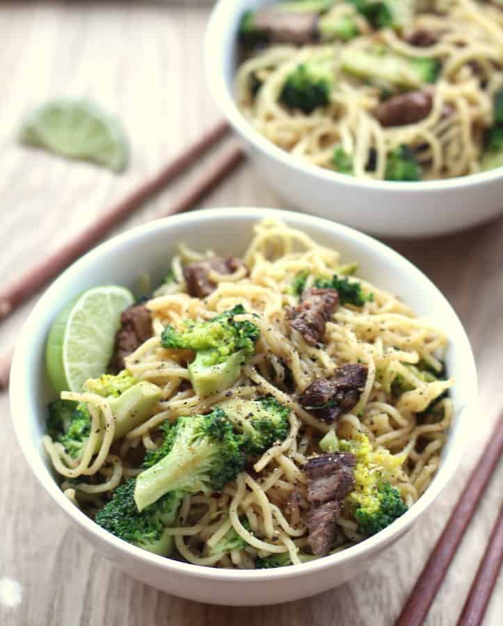 Beef and Broccoli over Noodles in a white bowl
