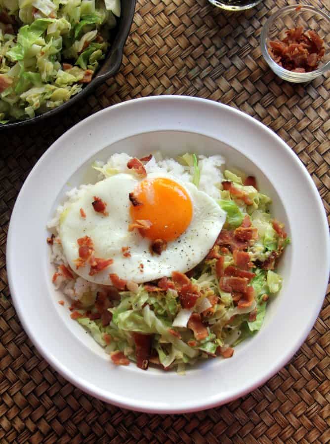 cabbage and a fried egg in a white bowl