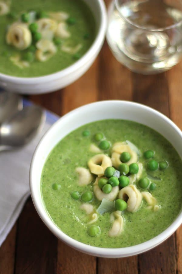 2 white bowls of pea and pesto soup