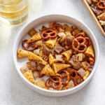 spicy chex mix in a white bowl