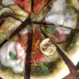 summer vegetable pizza cut into slices