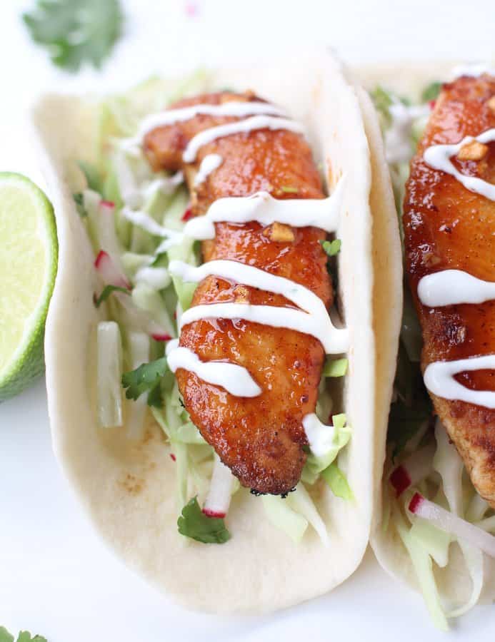 chicken tacos on a white plate