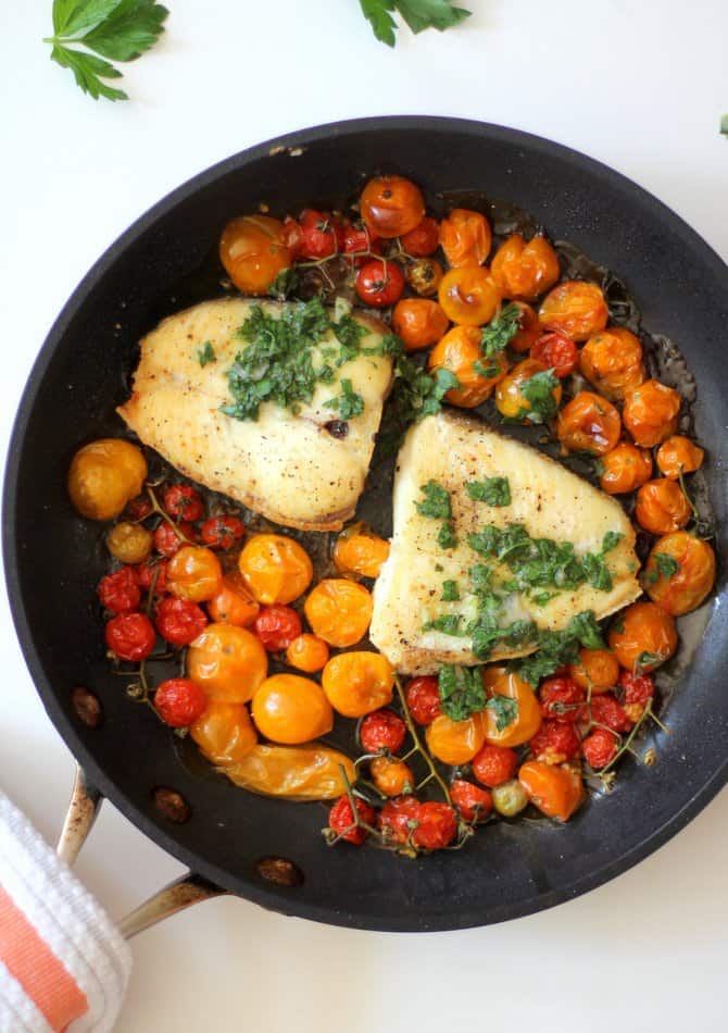 Slow Roasted Halibut with Burst Tomatoes in a skillet