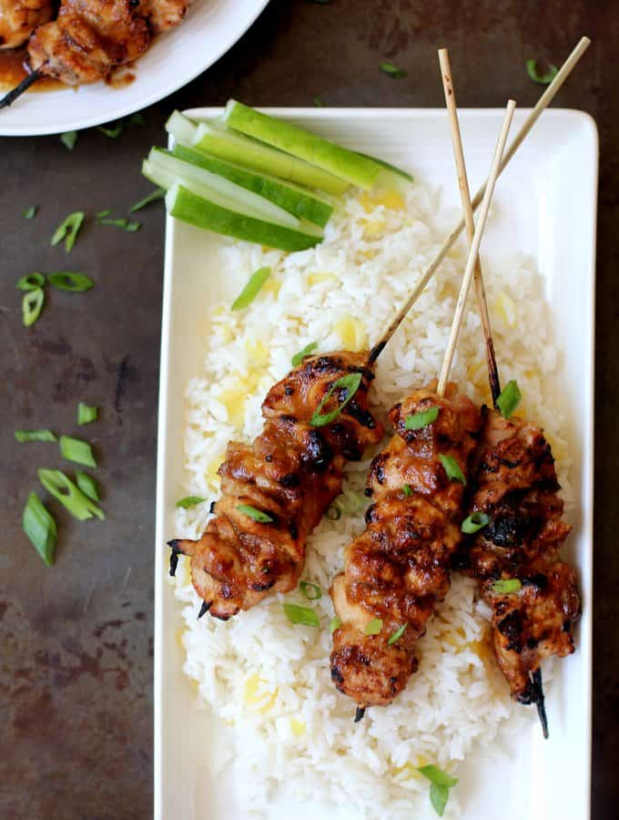 honey garlic Chicken Skewers over pineapple rice on a white tray