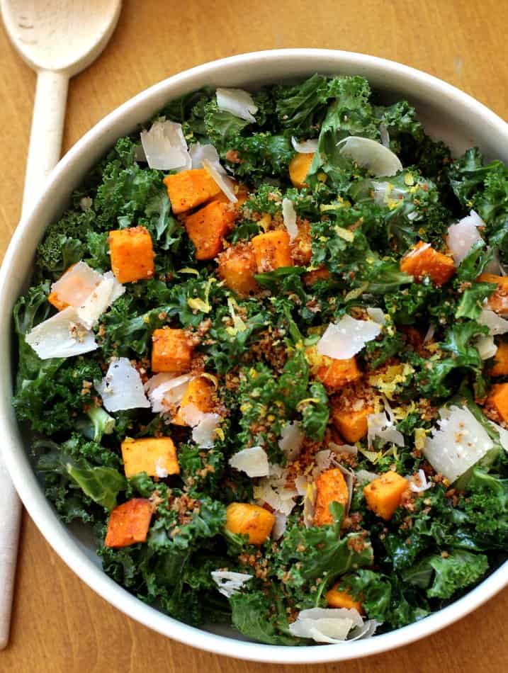 squash and kale salad in a white bowl