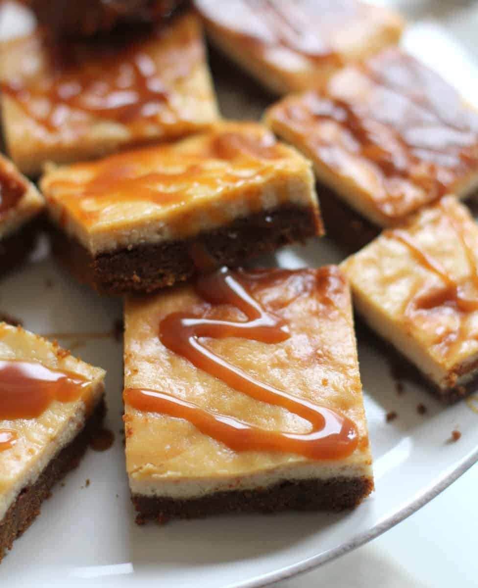Apple Cider Bars with Caramel Topping stacked on a white plate
