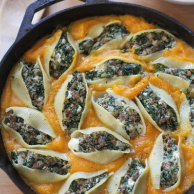 Sausage and Chard Stuffed Shells in a cast iron skillet