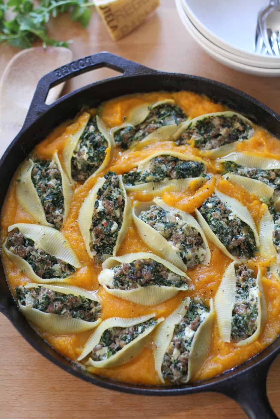 shells in a squash sauce in a cast iron skillet