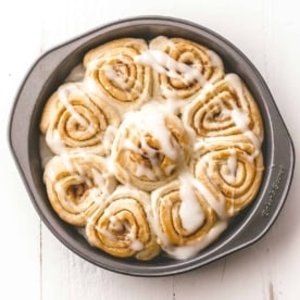 cinnamon rolls in a round baking pan