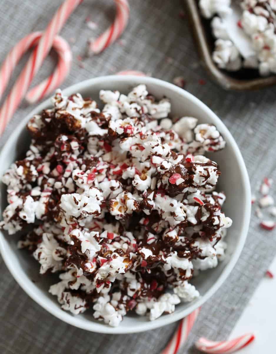 popcorn drizzled with chocolate and peppermint in a white bowl