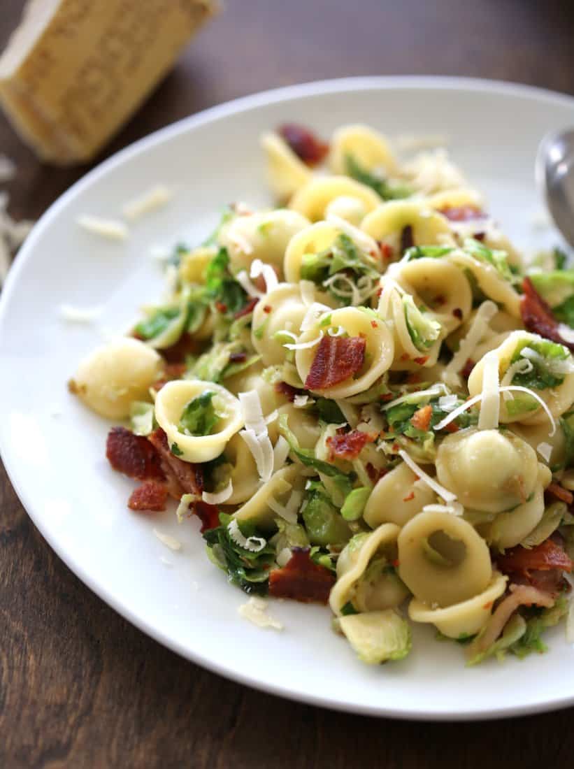 Orecchiette with Bacon and Caramelized Brussels Sprouts on a white plate