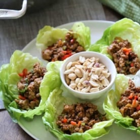 chicken lettuce cups on a white plate
