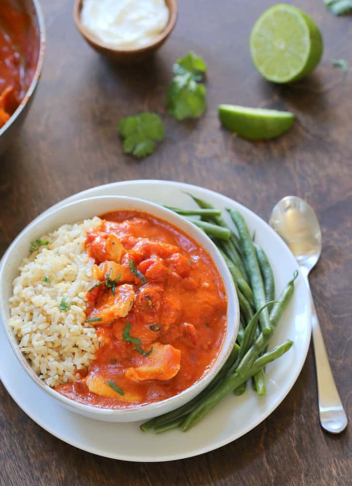 Chicken Tikka Masala over rice in a white bowl