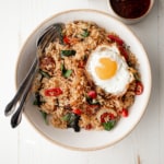 thai fried rice and a fried egg in a white bowl