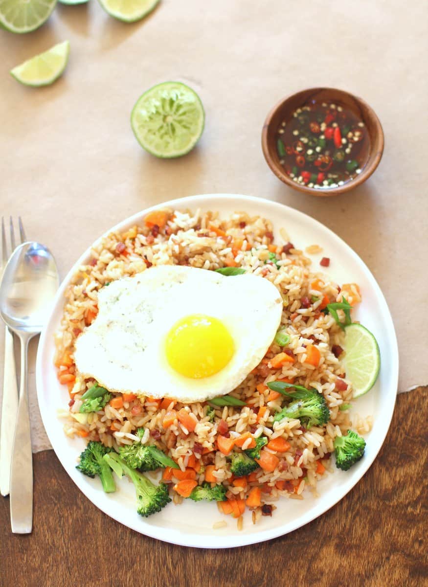 Thai Fried Rice on a white plate and topped with a fried egg