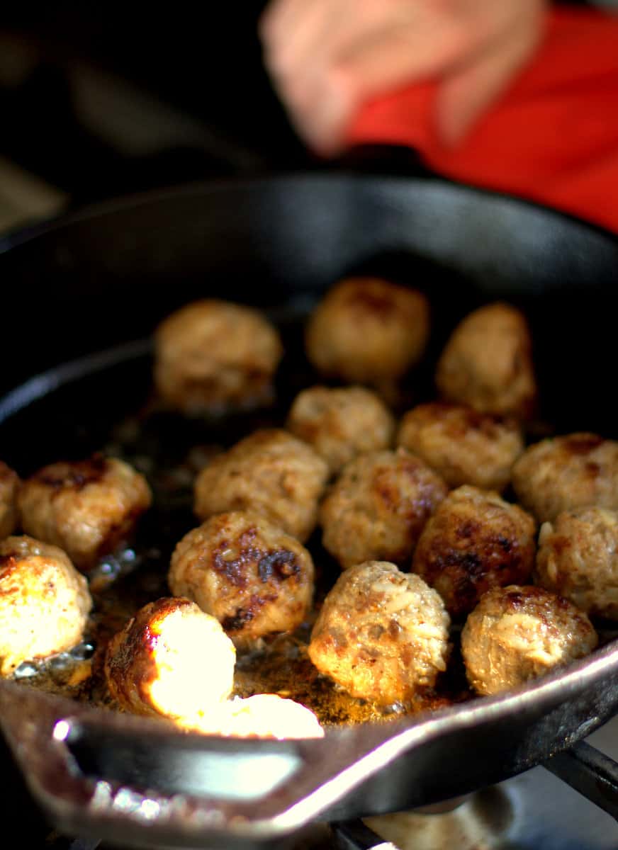browning meatballs in a cast iron skillet