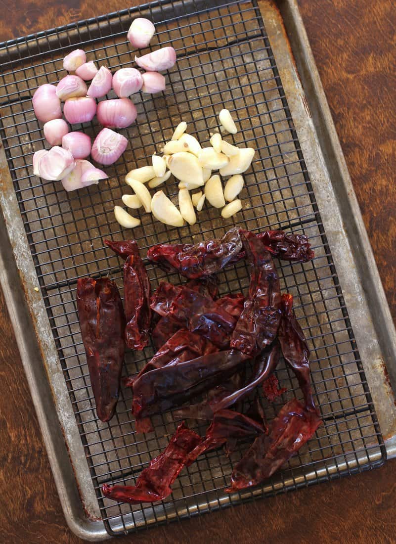 chilis, shallots and garlic on a metal rack