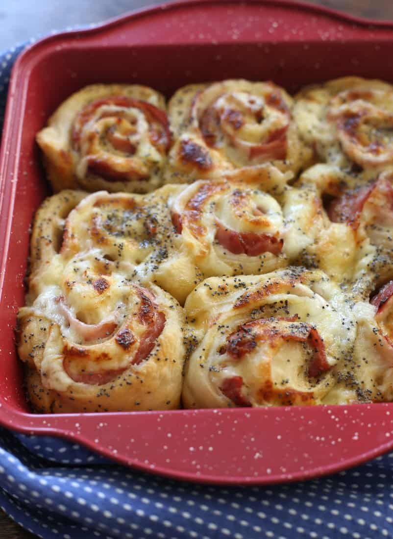 Baked Ham and Cheese Rolls in a red baking dish