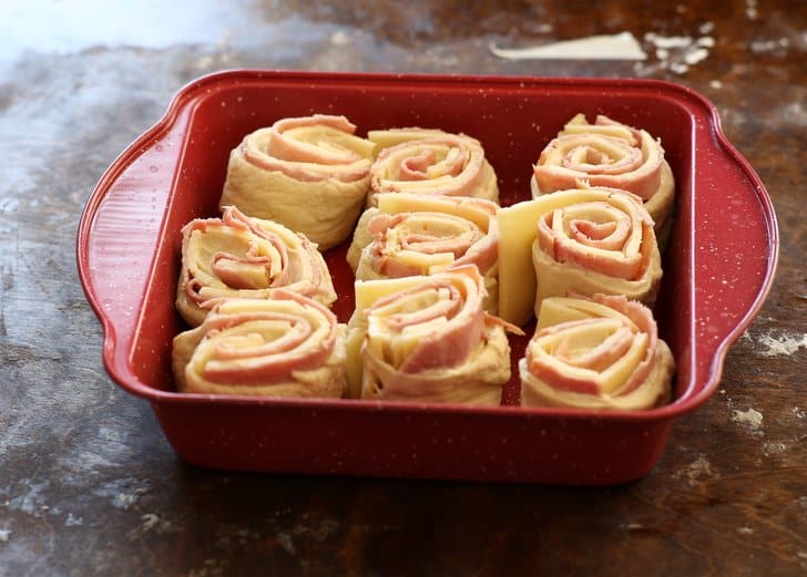 Ham and Cheese Rolls in a red baking dish