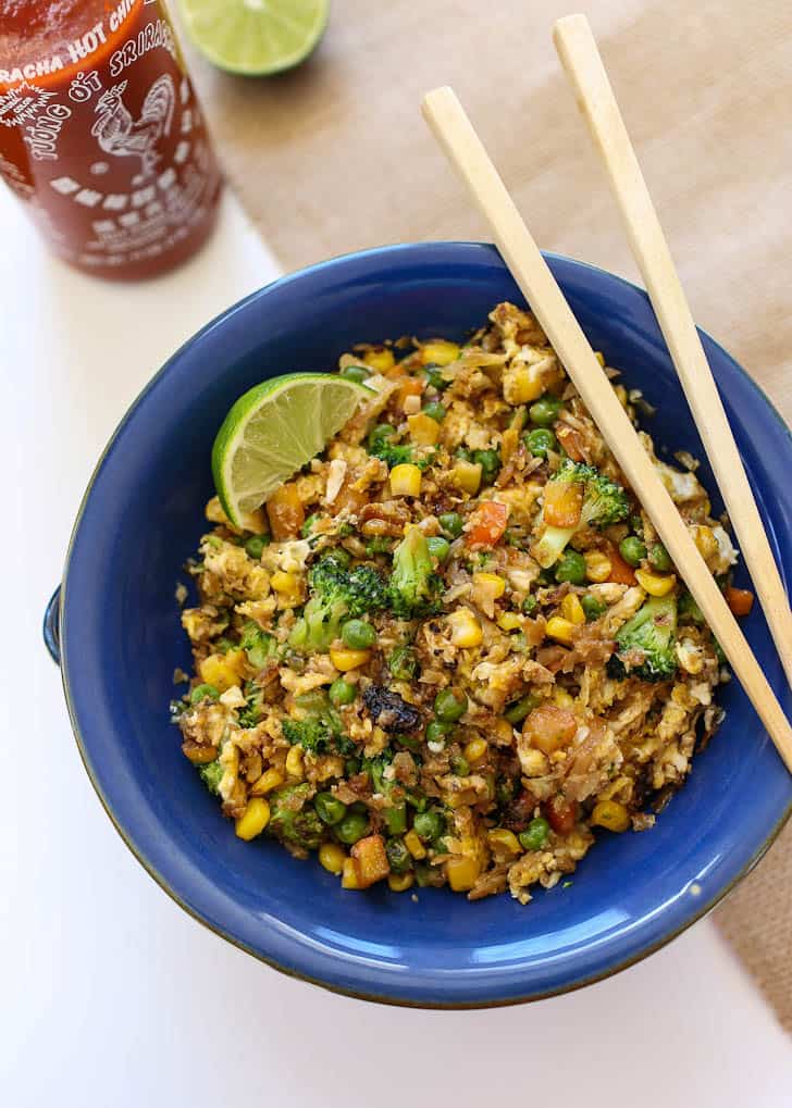 Cauliflower Fried Rice in a blue bowl with chopsticks