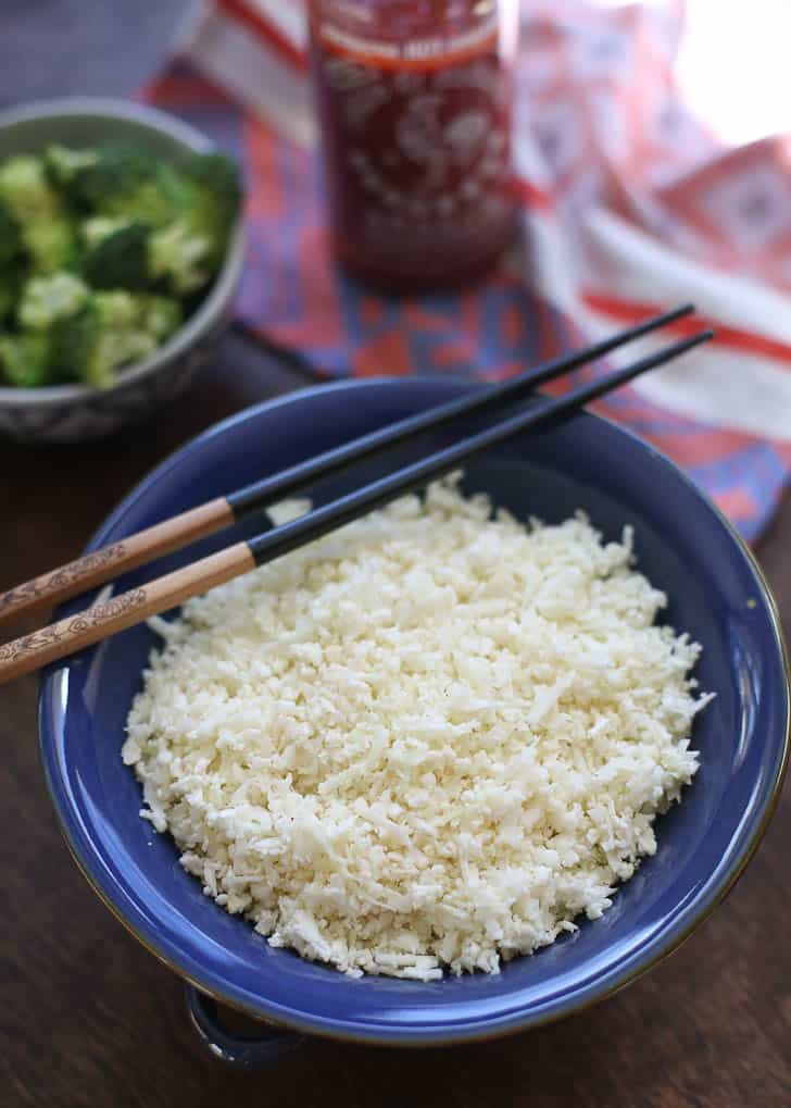Cauliflower Rice in a blue bowl with chopsticks
