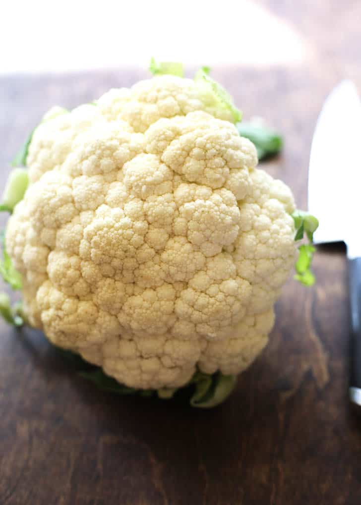 head of raw cauliflower on a wooden table