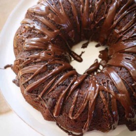 chocolate cake on a white cake plate