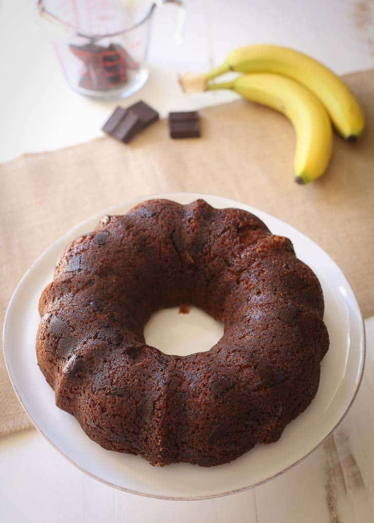 Bundt Cake with Chocolate on a white cake plate