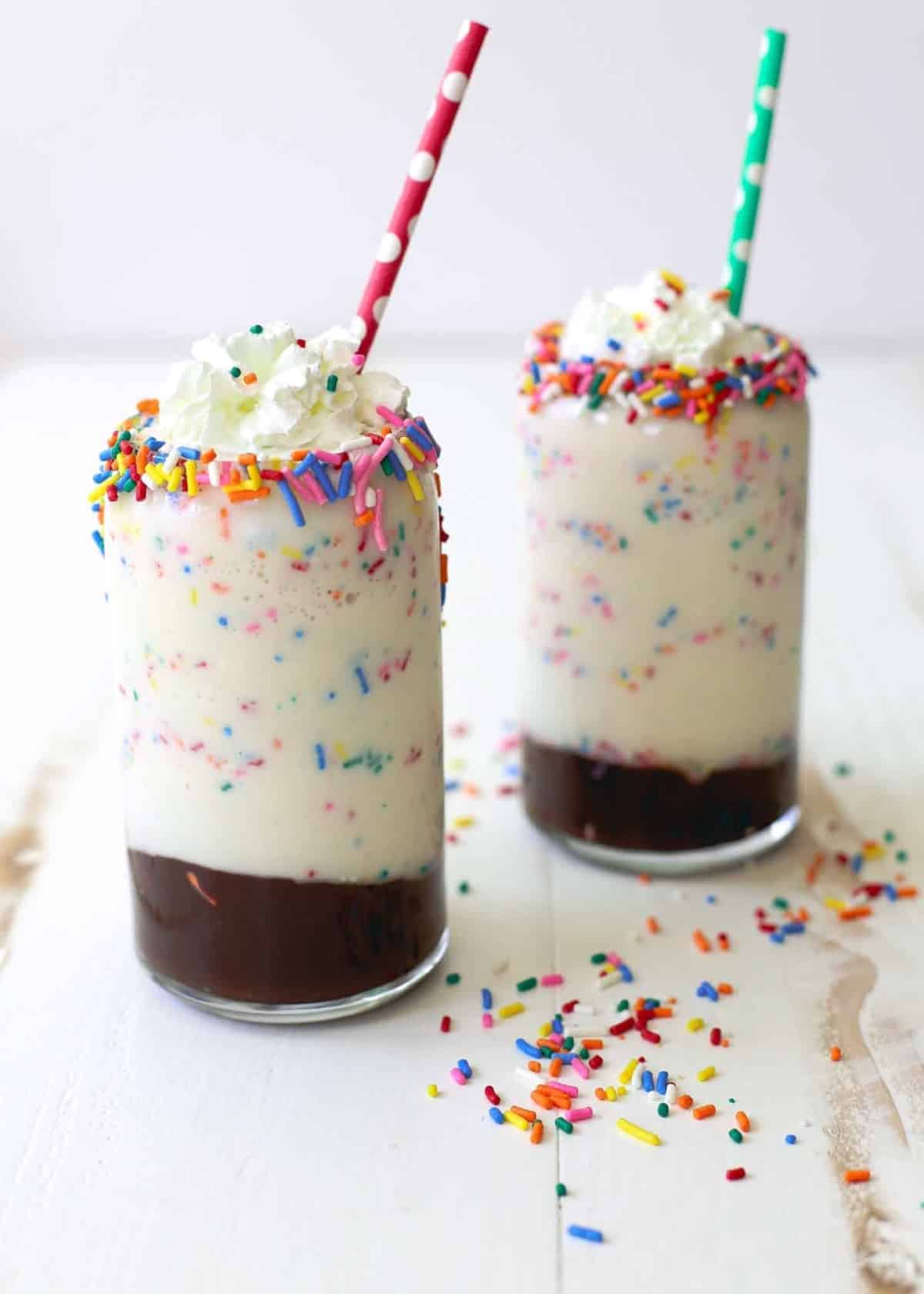 Cake Batter Milkshakes on a white table with multicolored straws