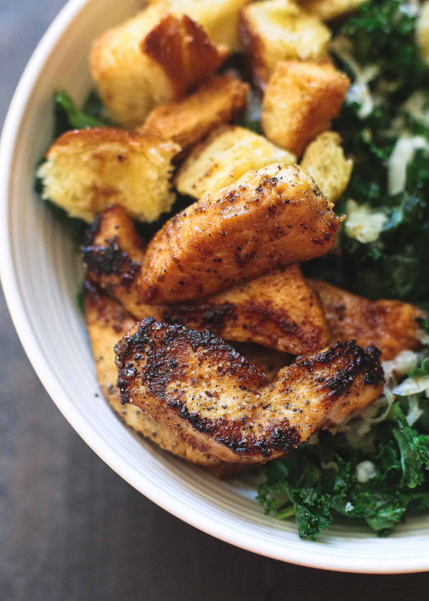 Kale Salad with Chicken in a white bowl
