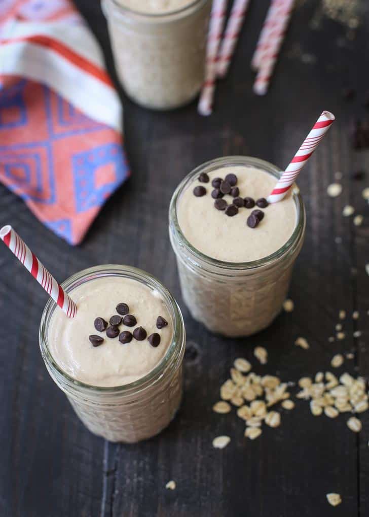 Smoothies in glass jars with red and white striped straws