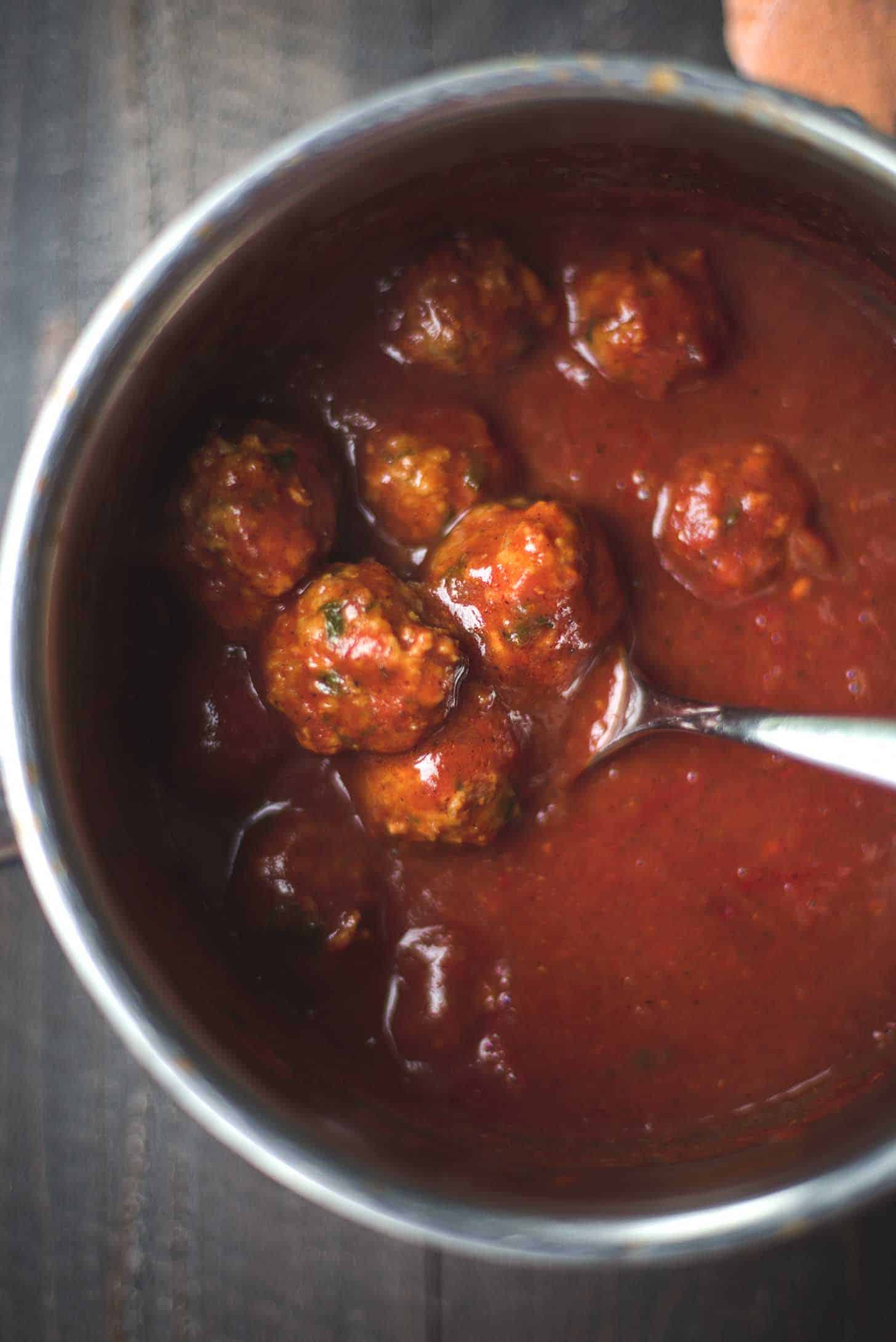 meatballs in homemade Enchilada Sauce in a saucepan