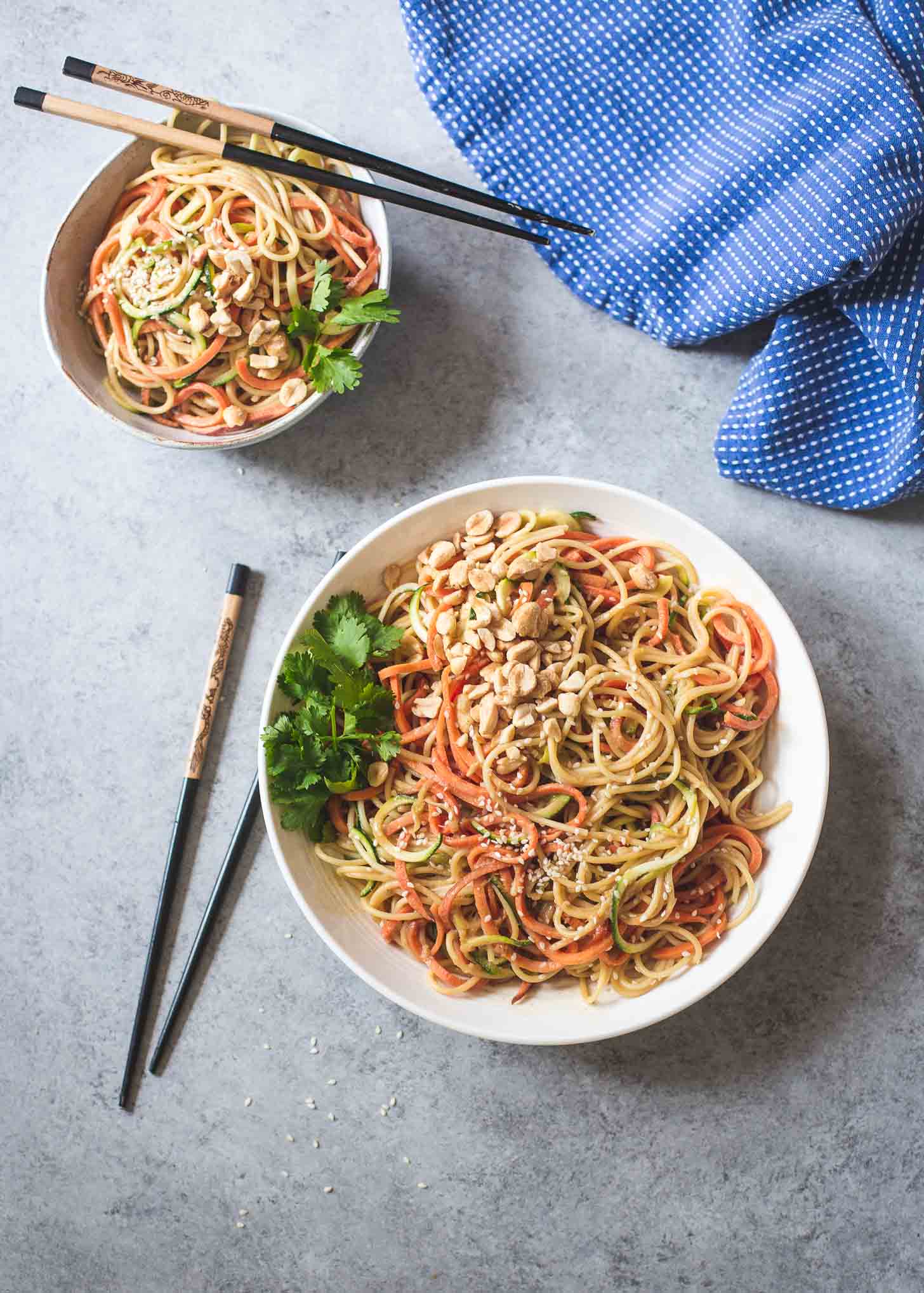 Sesame Peanut Noodles in white bowls with chopsticks