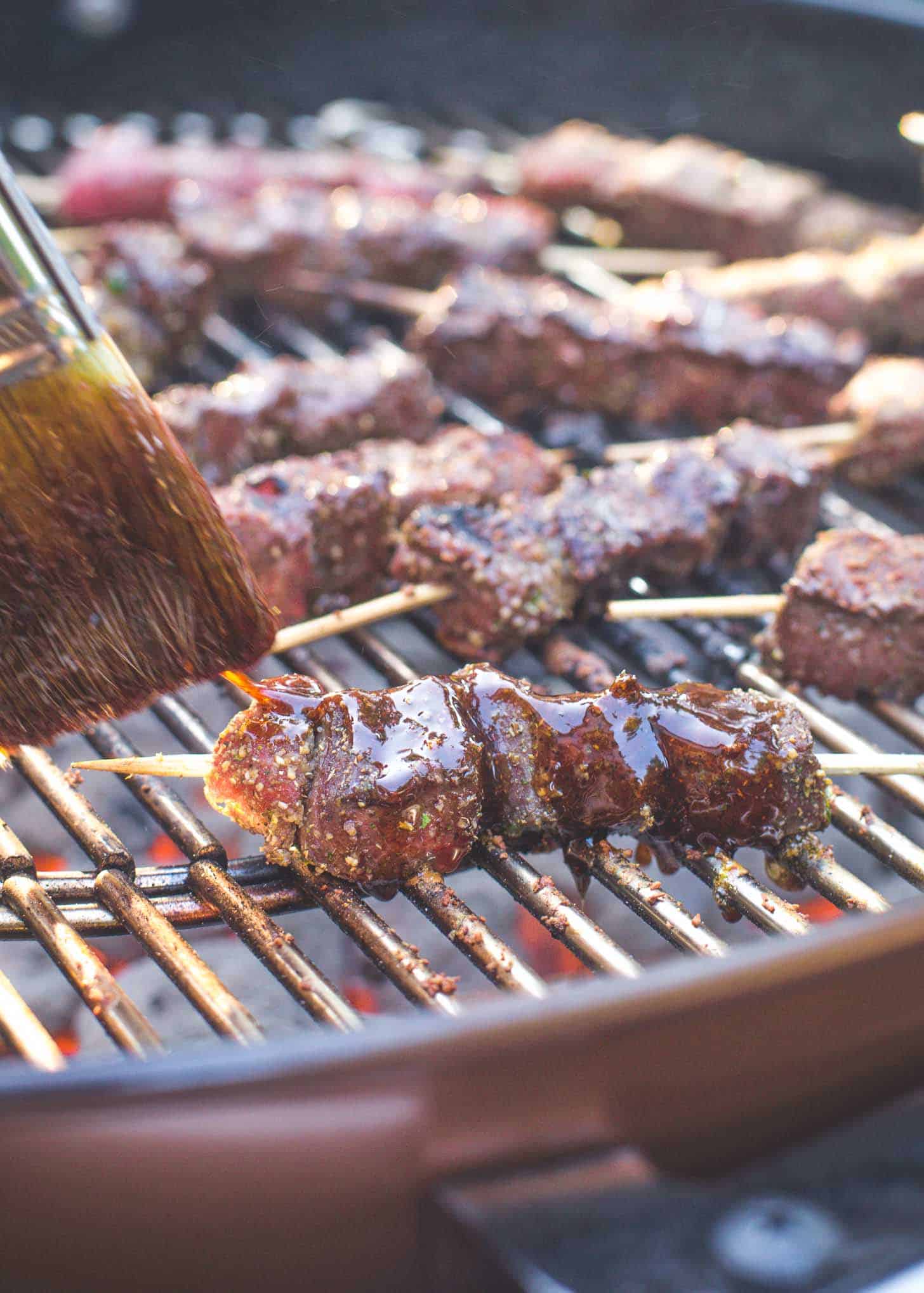 basting chili lime glazed Beef Skewers on the grill