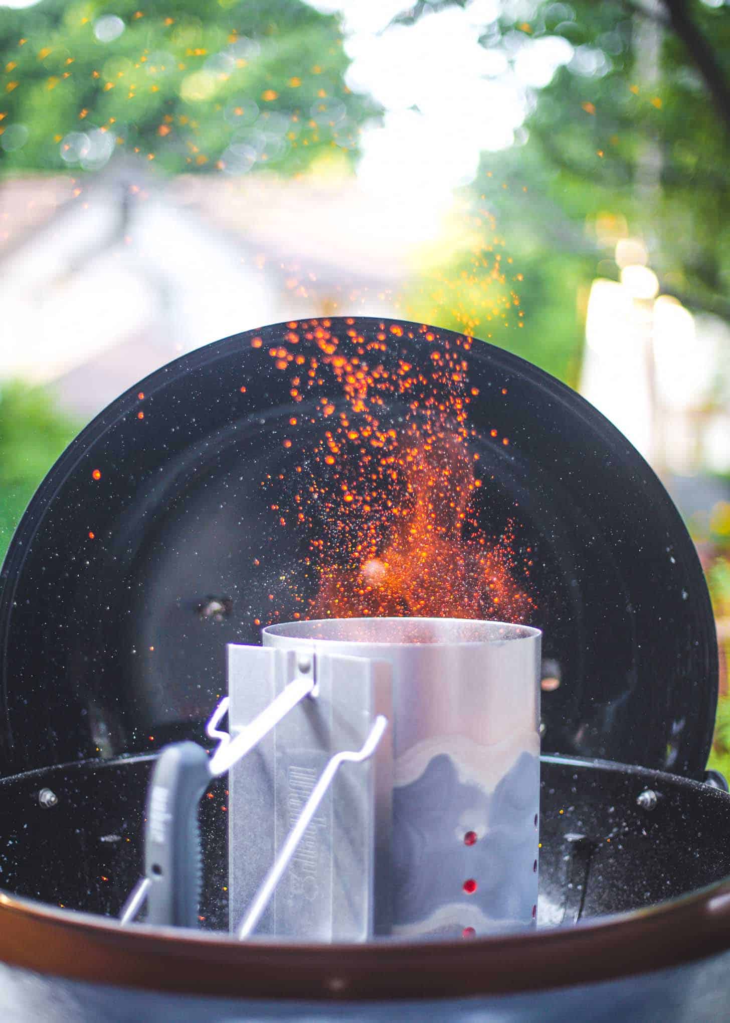 a charcoal grill with sparks coming out the top