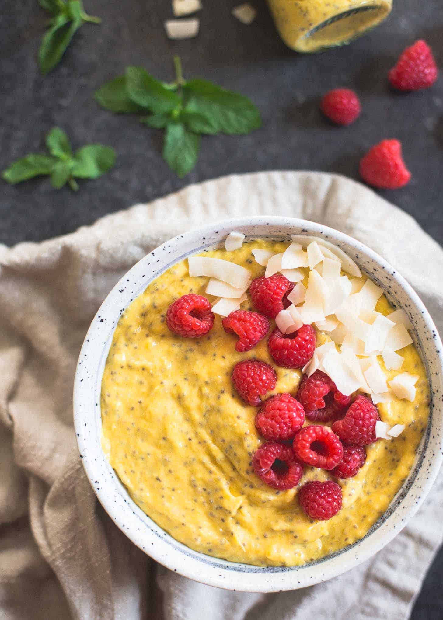 overhead image of mango breakfast bowl on a grey countertop