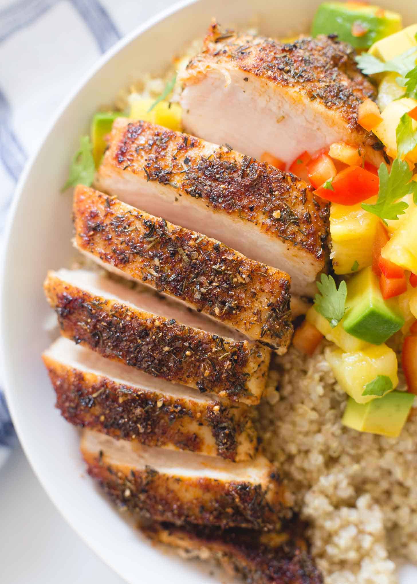 Caribbean Chicken sliced over a bowl of quinoa