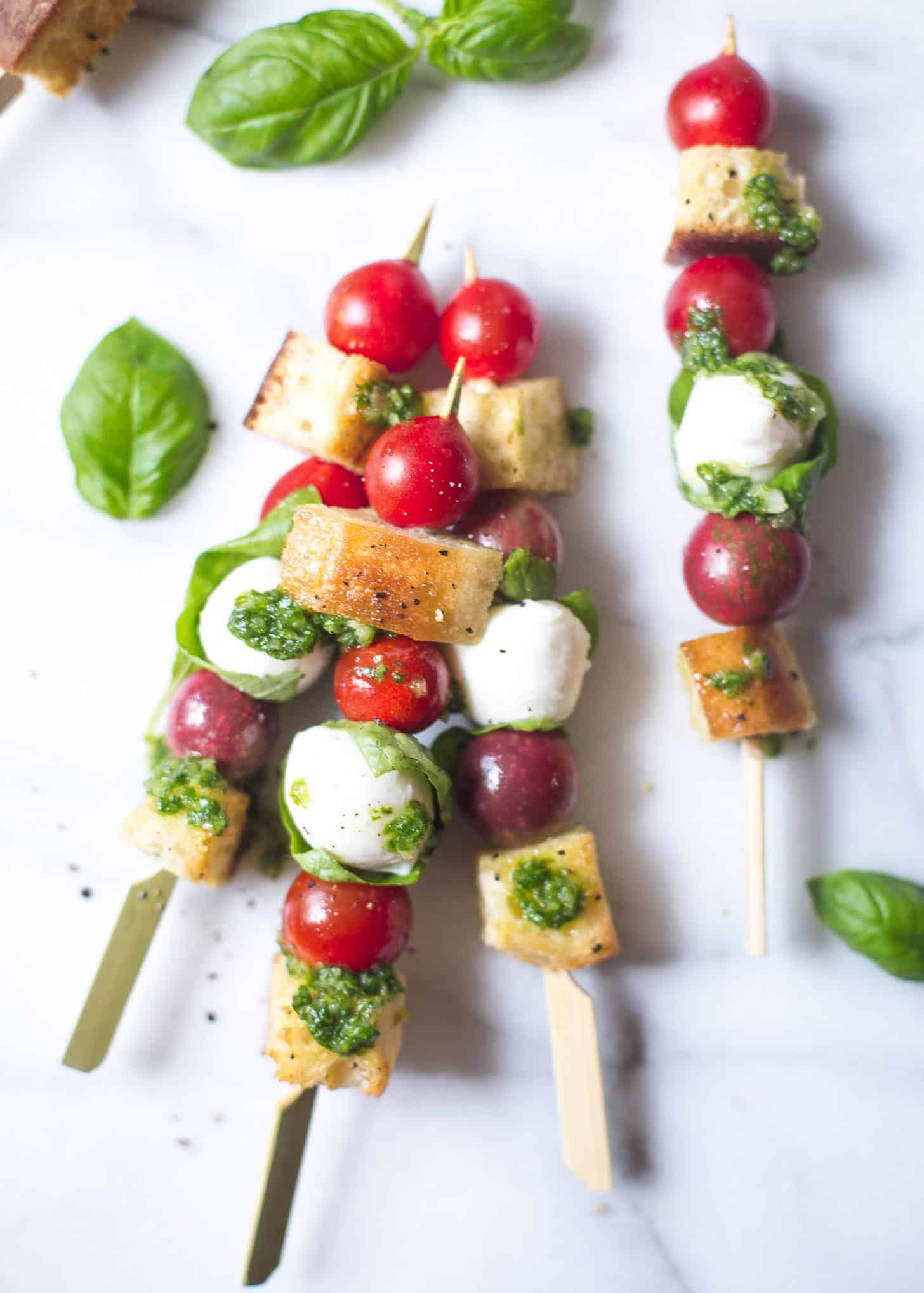 overhead image of panzanella skewers on a white table