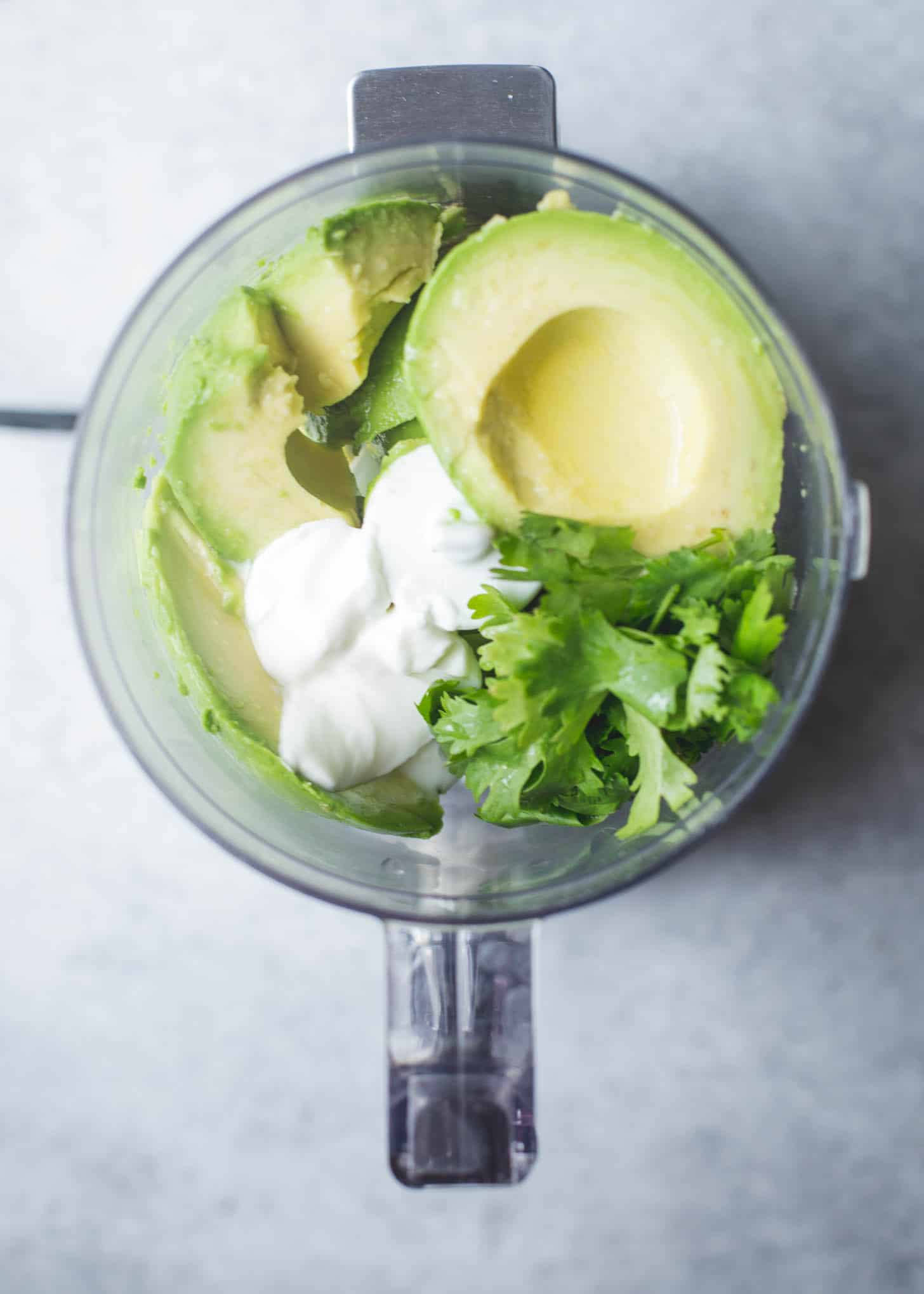 overhead image of avocados in a food processor