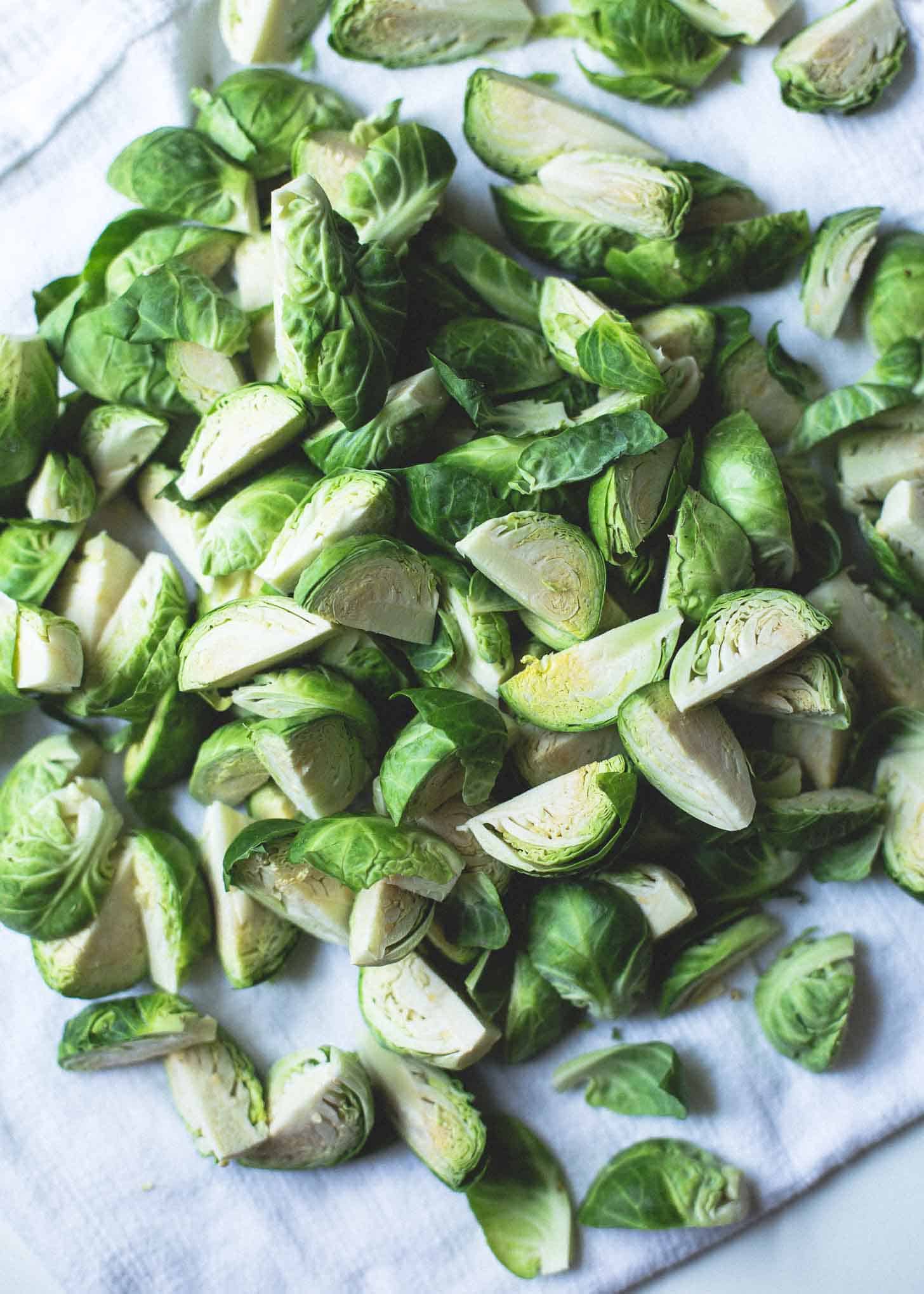 halved raw Brussels Sprouts on a white towel