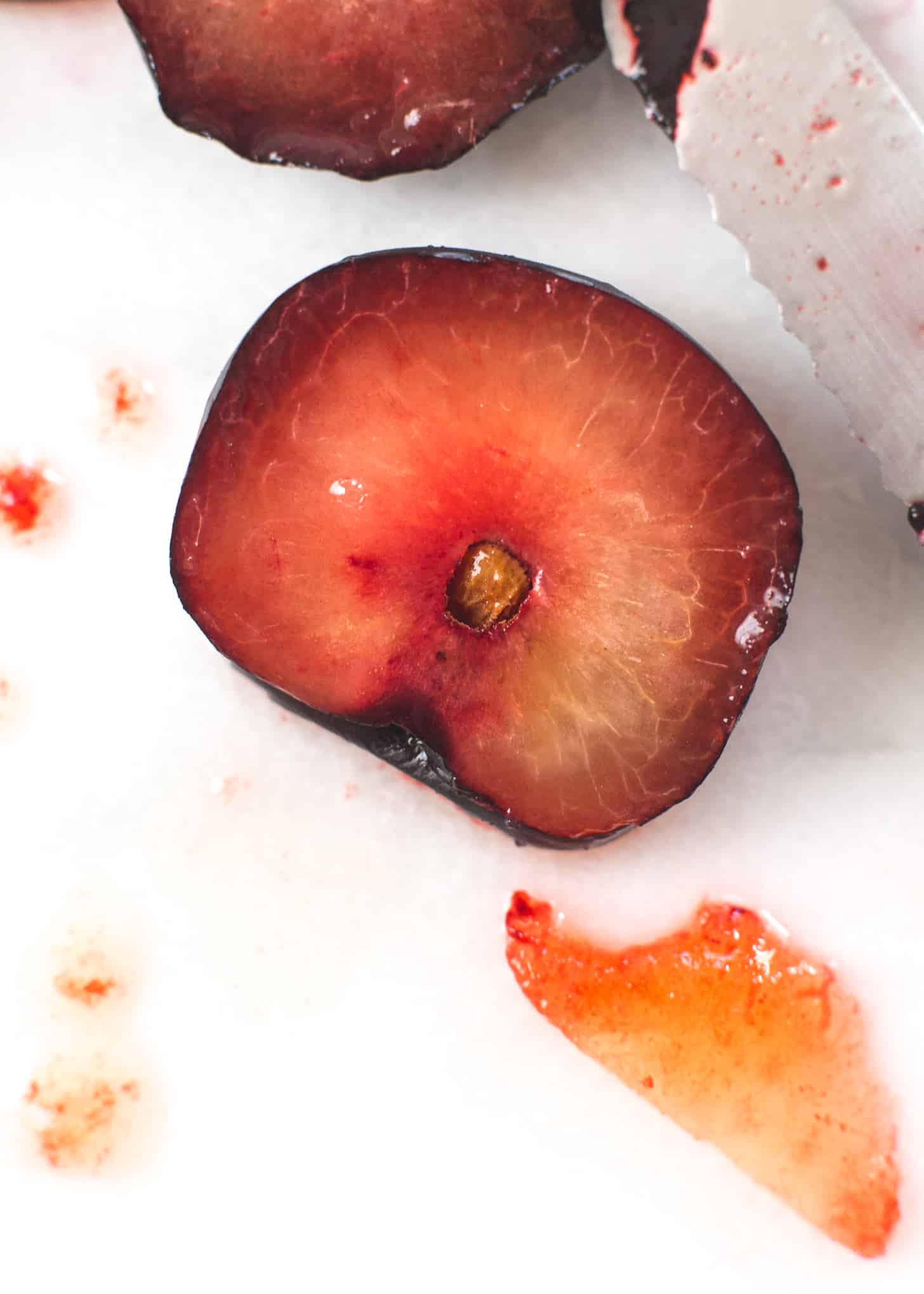 cut Plums on a white table