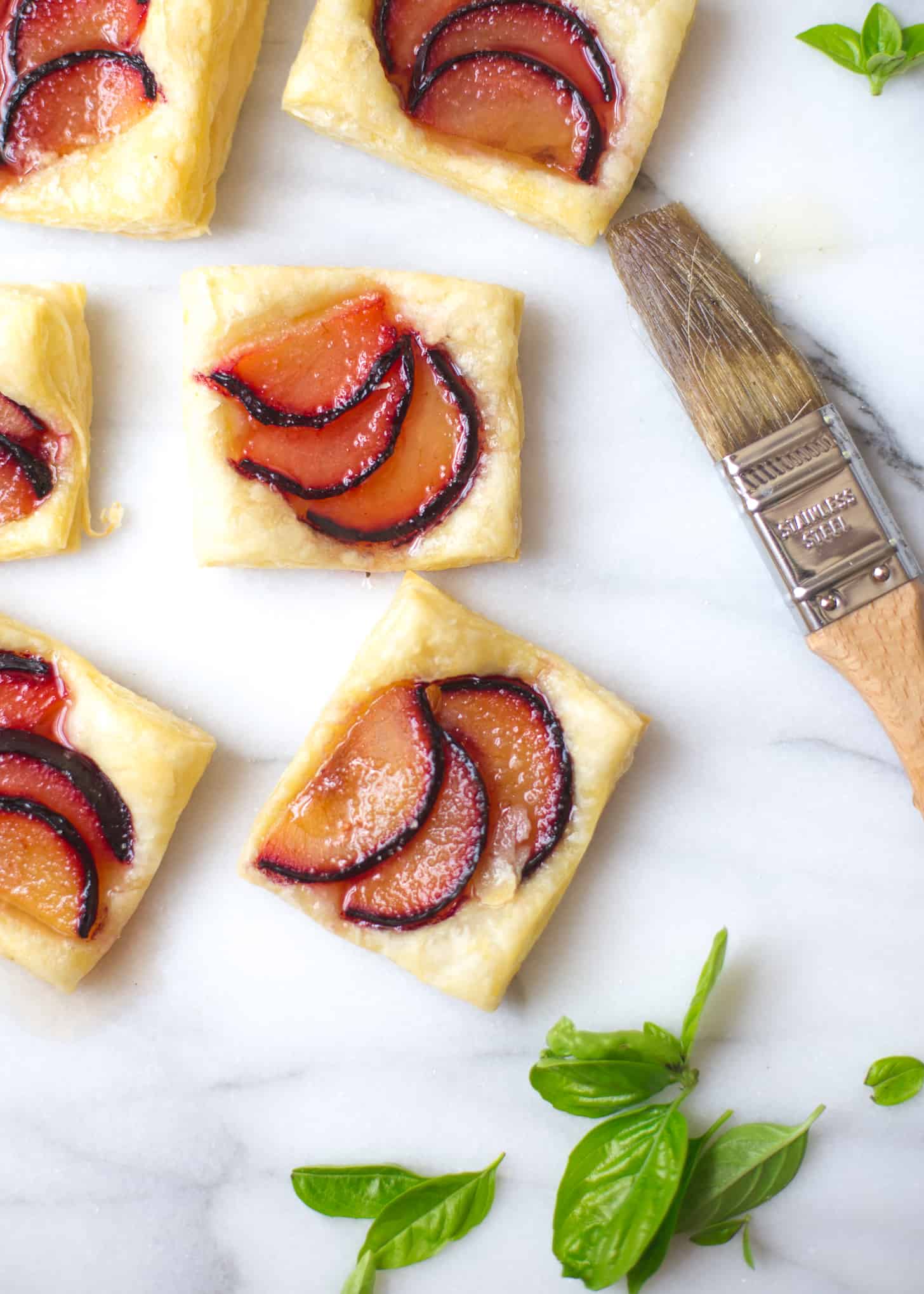 Plum Tarts with Sweet Basil Honey on a white countertop