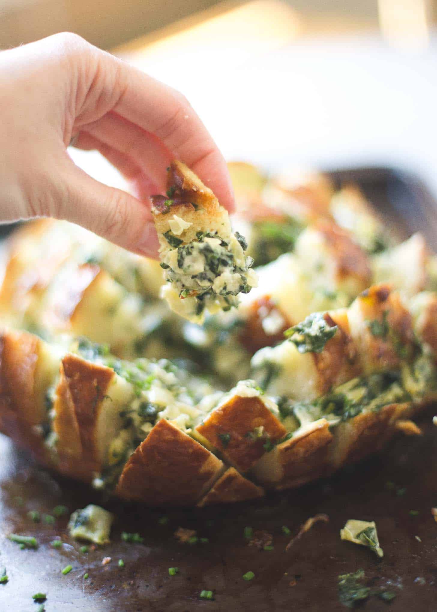 pulling a piece off of the pull-apart bread